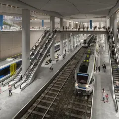 Moderne unterirdische Bahnhofshalle in Budapest mit Zügen, Rolltreppen und vielen Reisenden.