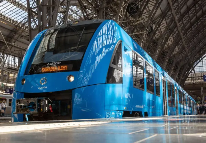 Ein blauer Alstom Coradia Lint Regionalzug steht im Bahnhof.