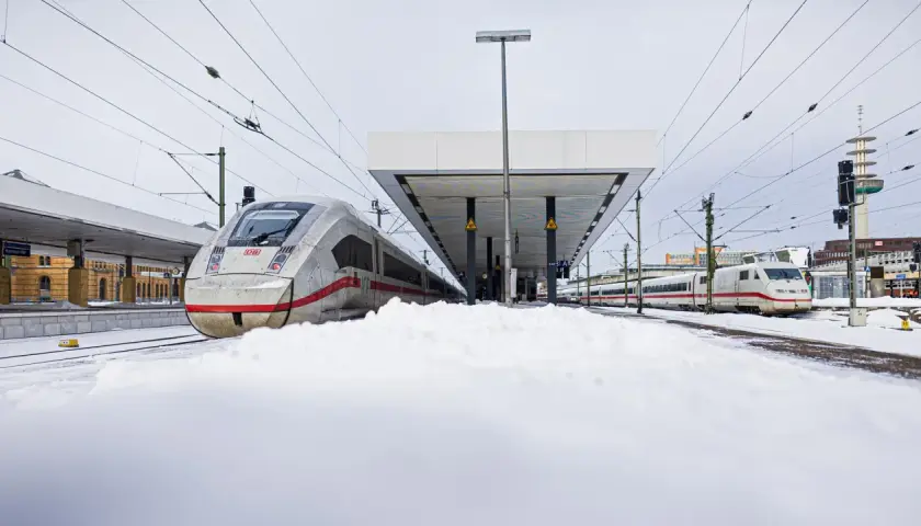 Zwei ICE-Züge stehen im Schnee am Bahnsteig. Das Streckennetz der Deutschen Bahn ist auch bei winterlichem Wetter einsatzbereit.
