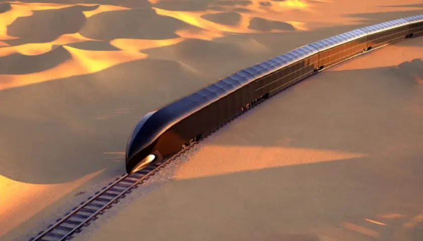 Ein futuristischer, dunkler Zug fährt durch eine goldene Wüstenlandschaft. Er könnte der teuerste Zug der Welt sein, eine Vision von Luxus und Technologie.